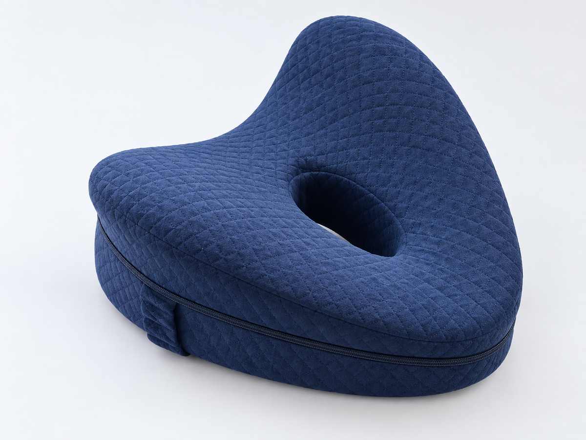 [siderest:hero] Navy SideRest contoured pillow on a light background.