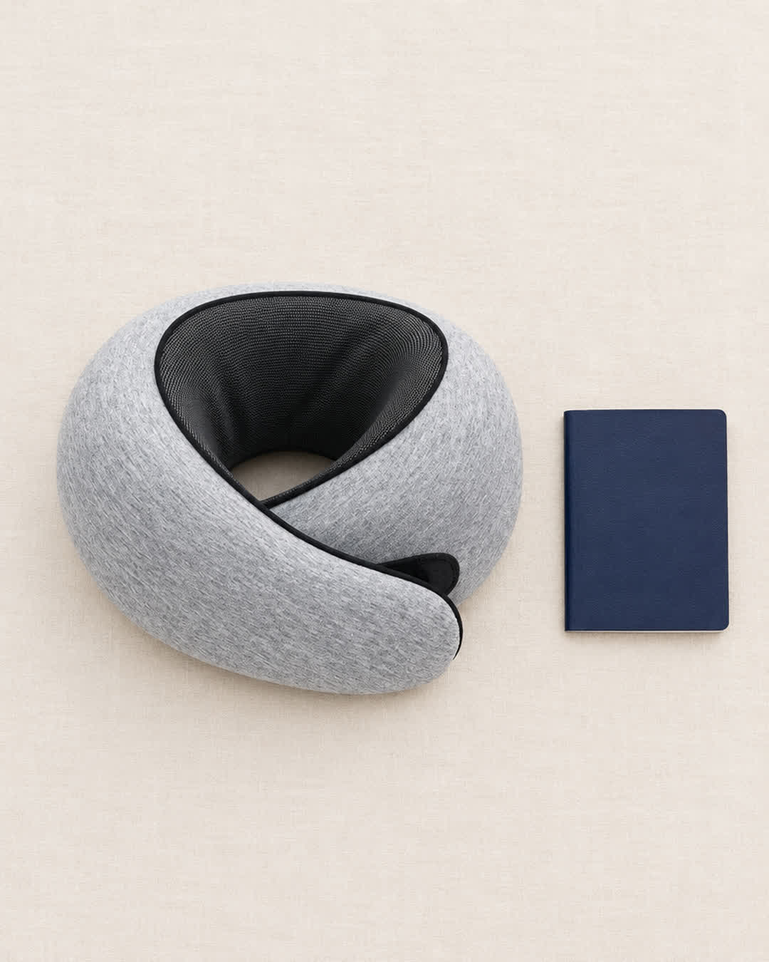 Snuggi Travel Neck Pillow next to a passport